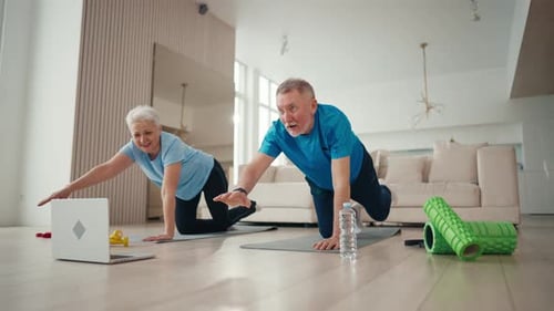 Mature Couple Doing Core Workout Together at Home