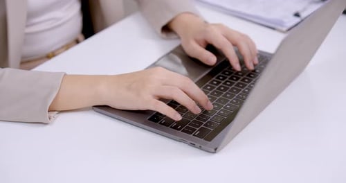 Close up of asian businesswoman typing on laptop keyboard, adult female professional working on