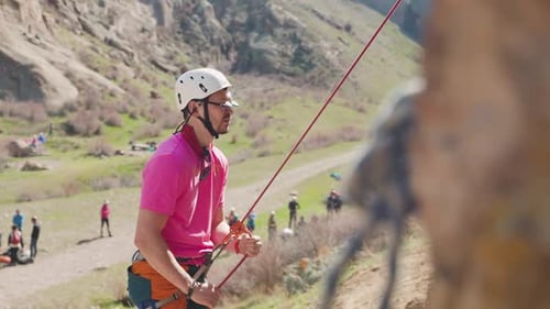 Man Athlete Climbing on the High Rock