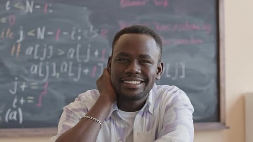Portrait of Happy Black Student in College Classroom