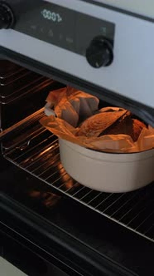 Whole wheat sourdough bread is taken out of the oven