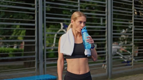 Athletic Woman Drinking Fresh Water From Fitness Bottle During Street Exercising