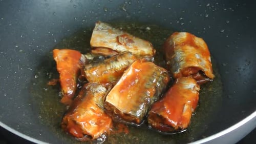 Frying Sardines in Tomato Sauce in Pan