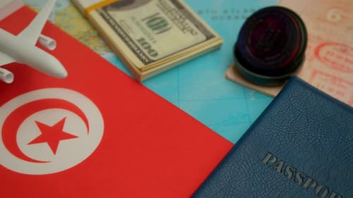 Travel Concept with Airplane, Passport, and Tunisian Flag