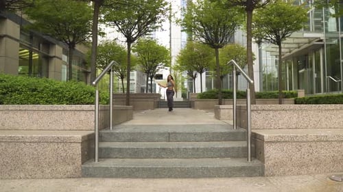 revealing shot of dancer moving like a snake in a park performing hip hop street dance moves dressed