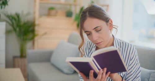 Woman Reading a Book in Sunny Living Room