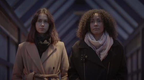 Lifestyle Portrait of Two Young Women Watching Tower Building Together