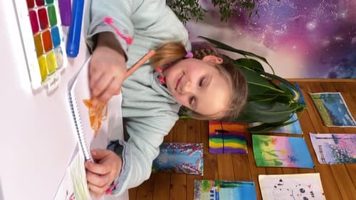 Boy and Girl Drawing Together in Room