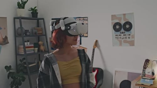 Teen Experiences Virtual Reality in Bedroom Setting