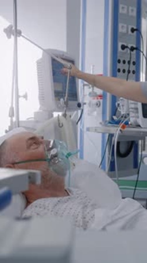 Friendly Nurse Adjusts Life Support Machine for Old Patient