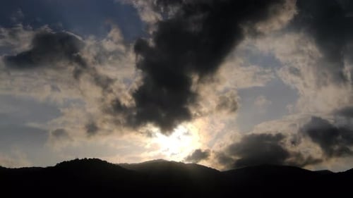 Dramatic Clouds Drifting Over Mountain Silhouette