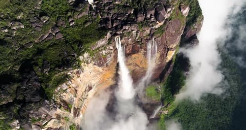 Aerial Drone View Of Massive Waterfall Dropping Into Misty Canyon