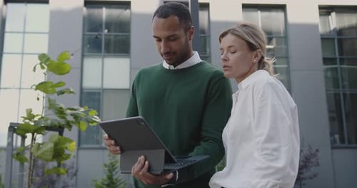 Business Discussion with Tablet in Urban Workplace