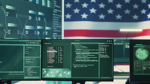 Computer Screens Display Code with American Flag Backdrop
