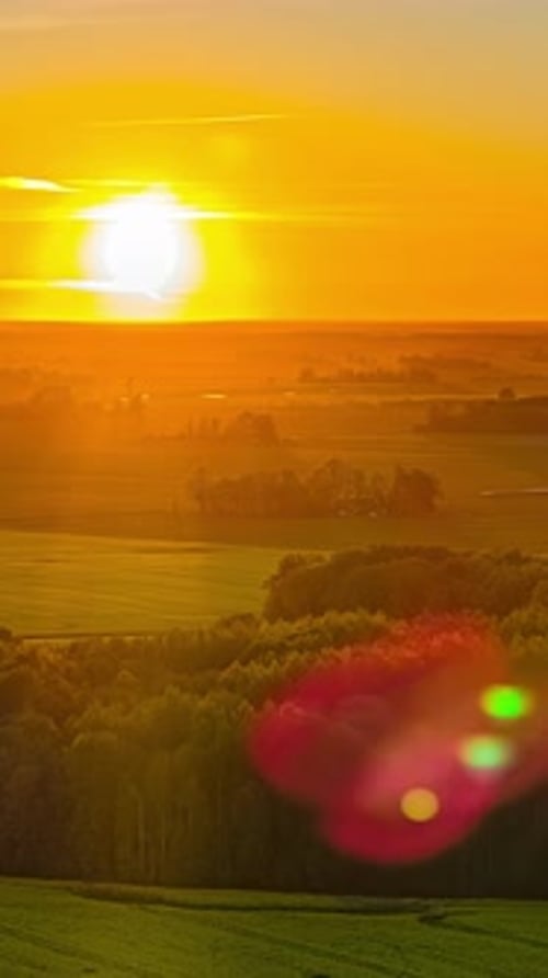 Breathtaking Vertical Timelapse of Fiery Sunset Over Expansive Fields