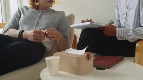 Female Client Relaxing on Couch at Psychologists Office
