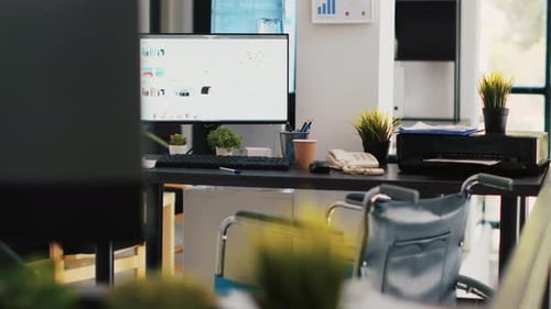Empty Bright Office with Computer and Wheelchair