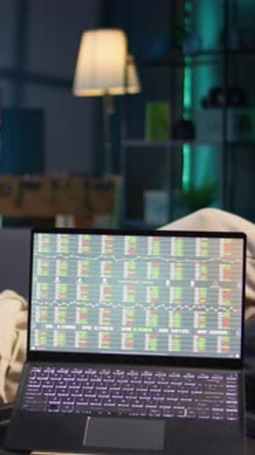 Vertical Video Man Enjoying Music and Reading e Books on Tablet While Waiting for Stock Market