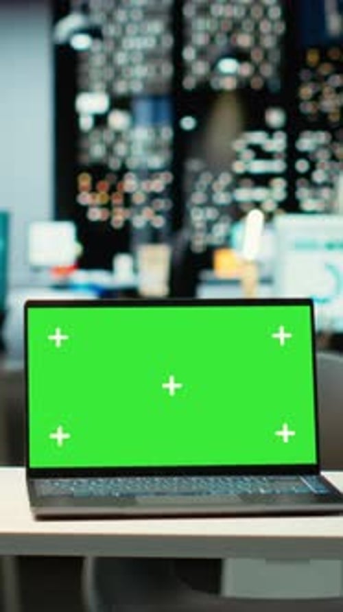 Vertical Video Empty Corporate Workspace with a Green Screen Laptop in a Multinational Company