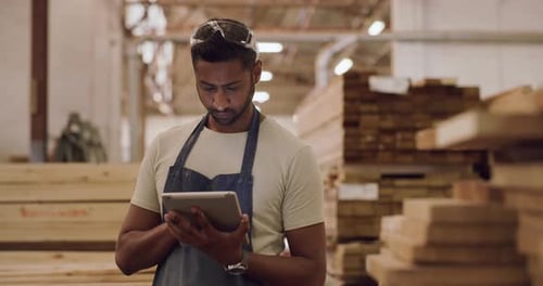 4k video footage of a young man using a digital tablet while working in a workshop