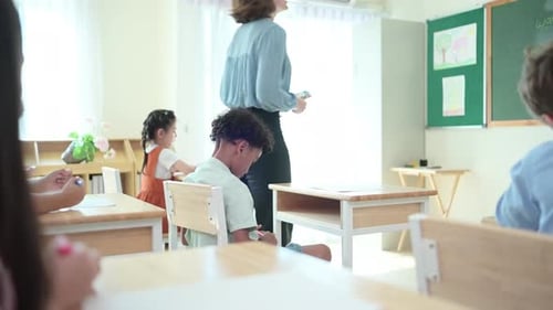 Teacher and students, Learn and study in a classroom of school where youngsters sit and listen