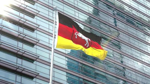 Waving Lower Saxony Flag on Modern Building Background