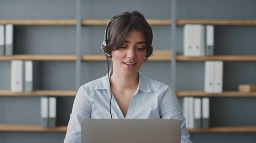 Young Woman Conducts Online Lessons From Her Home Office with a Laptop