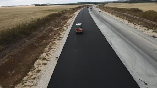 Roller Truck Presses Asphalt Covering on Highway Road Lane
