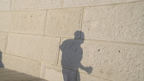Shadow of a man running at sunset