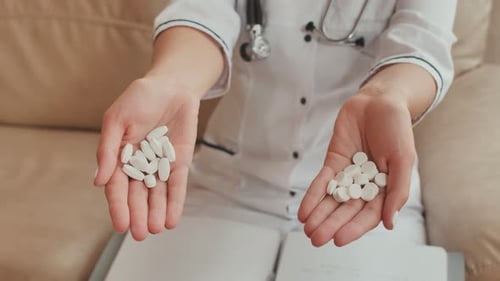 Close Up of Pills in Doctor's Hands