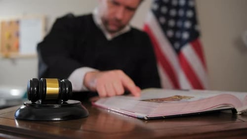 Judge's Hand with Wooden Judge Gavel Focus on Judge Gavel Slow Motion View