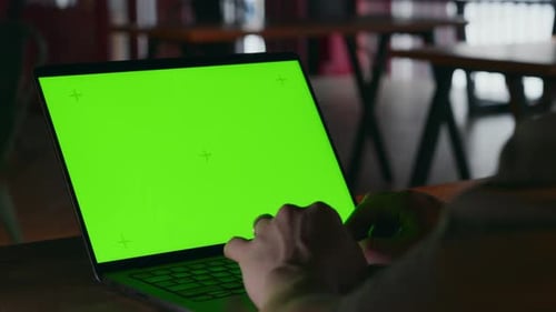 A Closeup of a Laptop Screen with a Green Screensaver for Motion Graphics