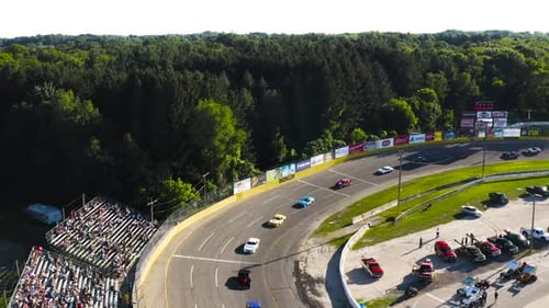 Aerial View of Racecars Speeding Around Track