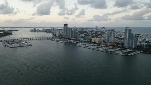 Aerial high angle footage of Miami south beach bridge avenue connecting to downtown