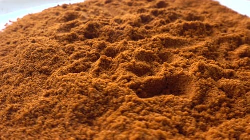 Vibrant Pile of Finely Ground Orange-Brown Spice