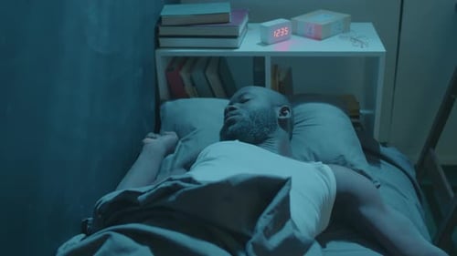 Man Sound Asleep in Bed at Night