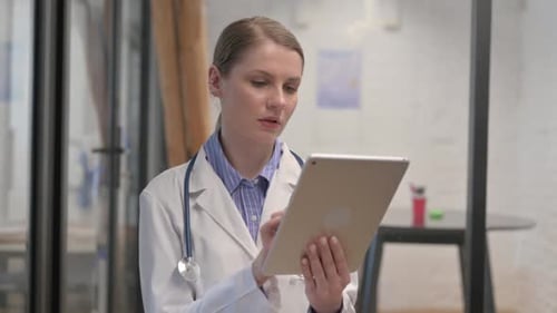 Female Doctor Using Tablet in Modern Clinic