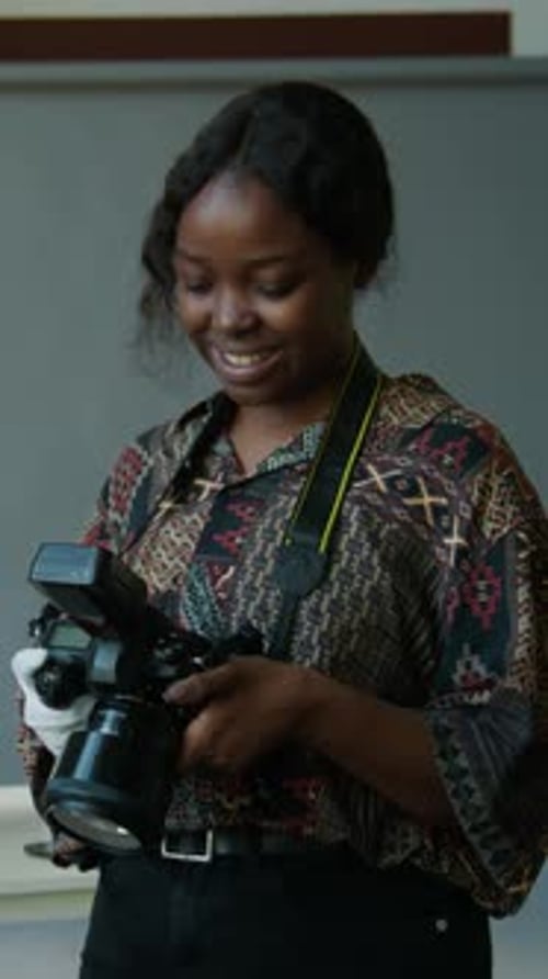 Happy Female Photographer at Work in Studio