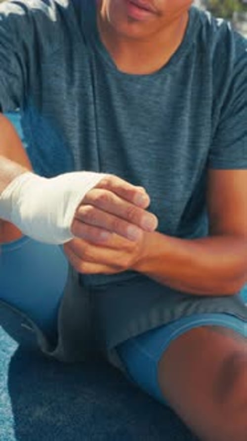 Bandage, sports injury and tennis court with hands of person for joint inflammation
