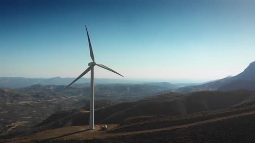Modern power turbines on top of mountain against sky