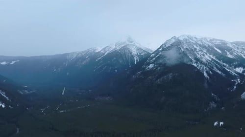 Aerial View of Winter Rocky Mountains During the Snowfall