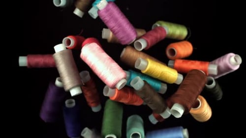 Colorful Spools of Thread on a Black Background