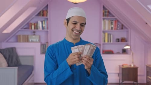 Man Counting Money in Bright Home Interior