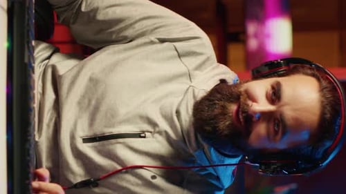 Young Adult Using Computer With Headphones