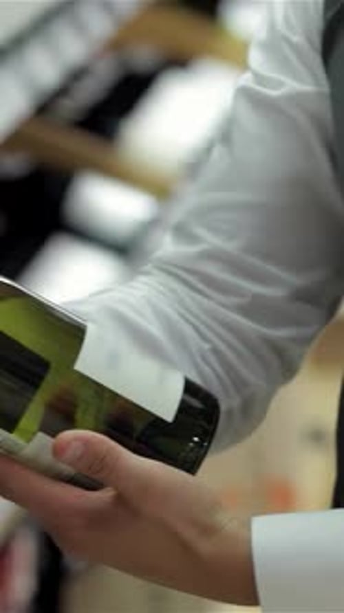 Examining Wine Bottle Label in Urban Setting