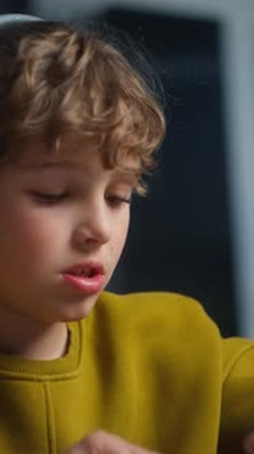 Closeup Shots of a Young Boy with Curly Hair Wearing a Mustard Green Sweater Showing Thoughtful