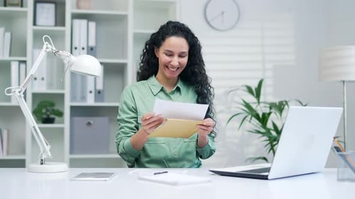 Woman Celebrates Good News in Bright Office