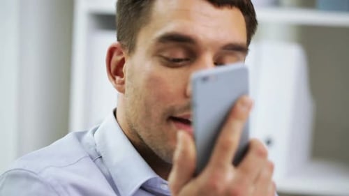 Man talking on phone at his office desk