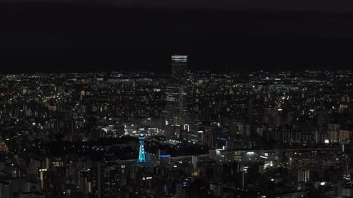 Aerial Panoramic View of Metropolis at Night Tall Modern Skyscraper Towering Above Surrounding Town