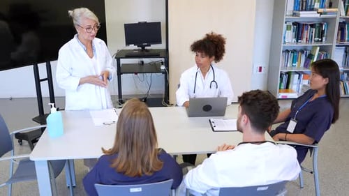 Medical Team Meeting Discussing Patient Care in Hospital Conference Room